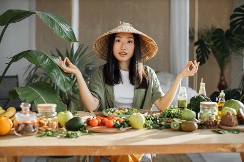 young asian woman sitting near table with organic