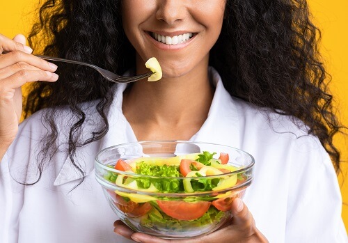 women with a vegetable bowl