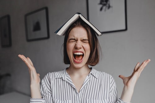 girl with a book on her head tries to emotionally Balance herself for morning mindfulness